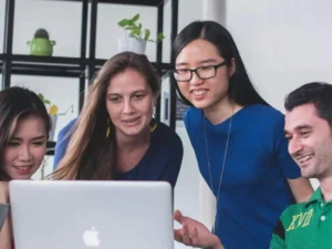Hip friends watching a laptop screen.