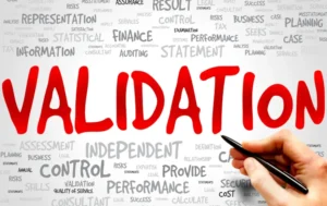 Hand holding a pen with the word validation highlighted among related terms.