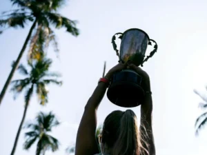 Silhouette of a woman holding a trophy.
